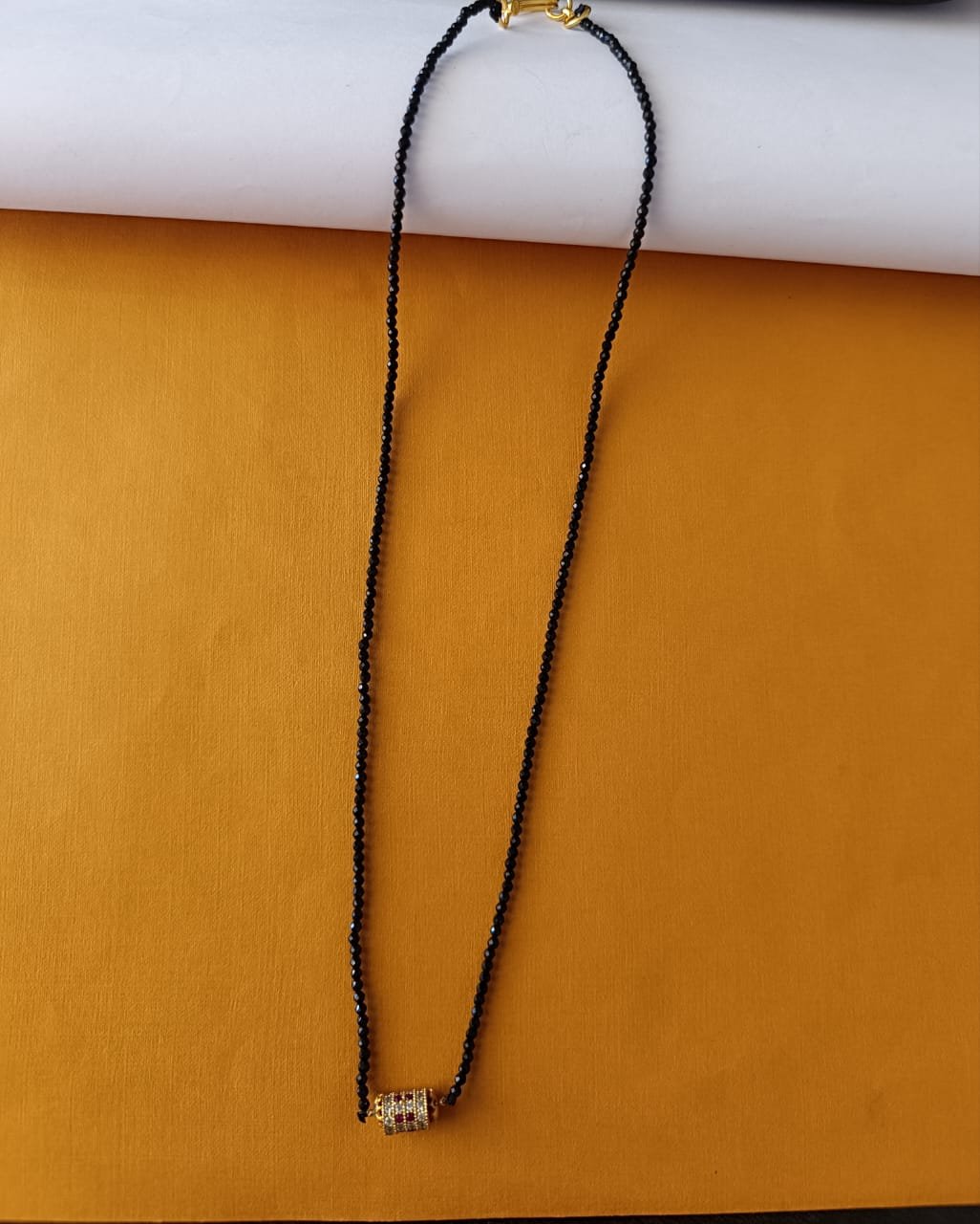 Black beads chain single line with gold boll