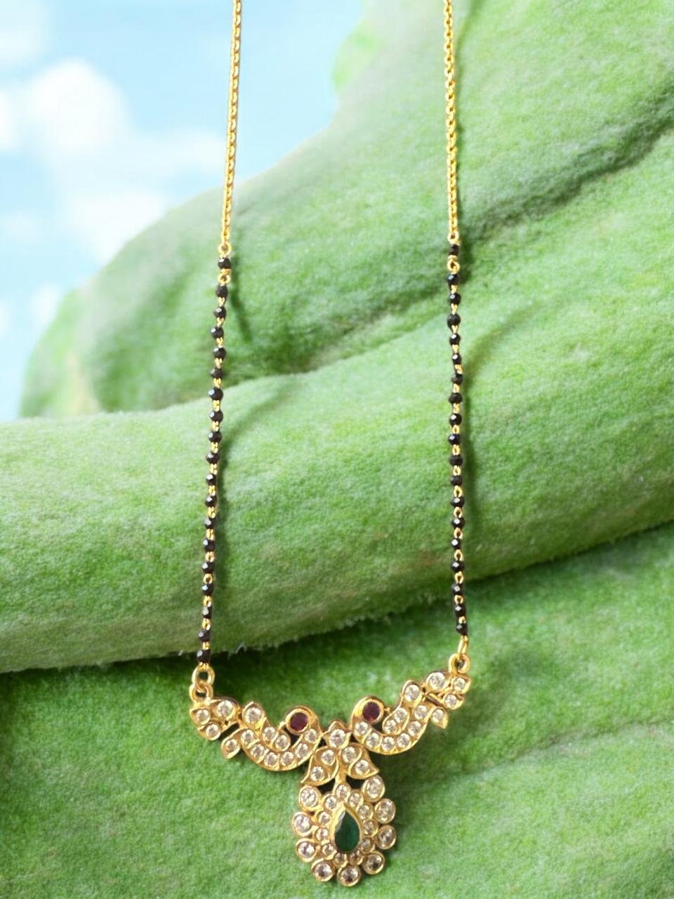 Black beads chain with cz stones and ruby and green stones with gold polish