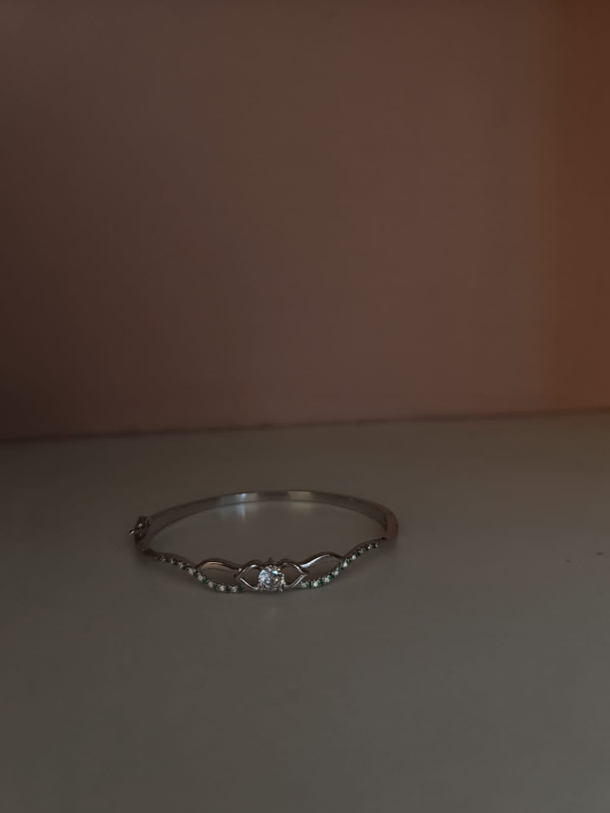 Green stones and white stones with silver polish Bracelet