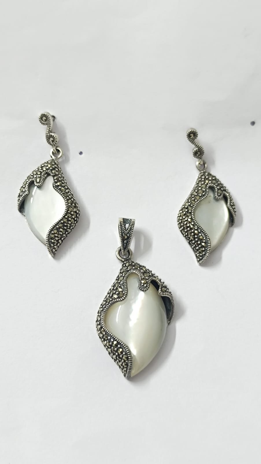 Marker stones with  silver polish and white  big  stones  pendent set