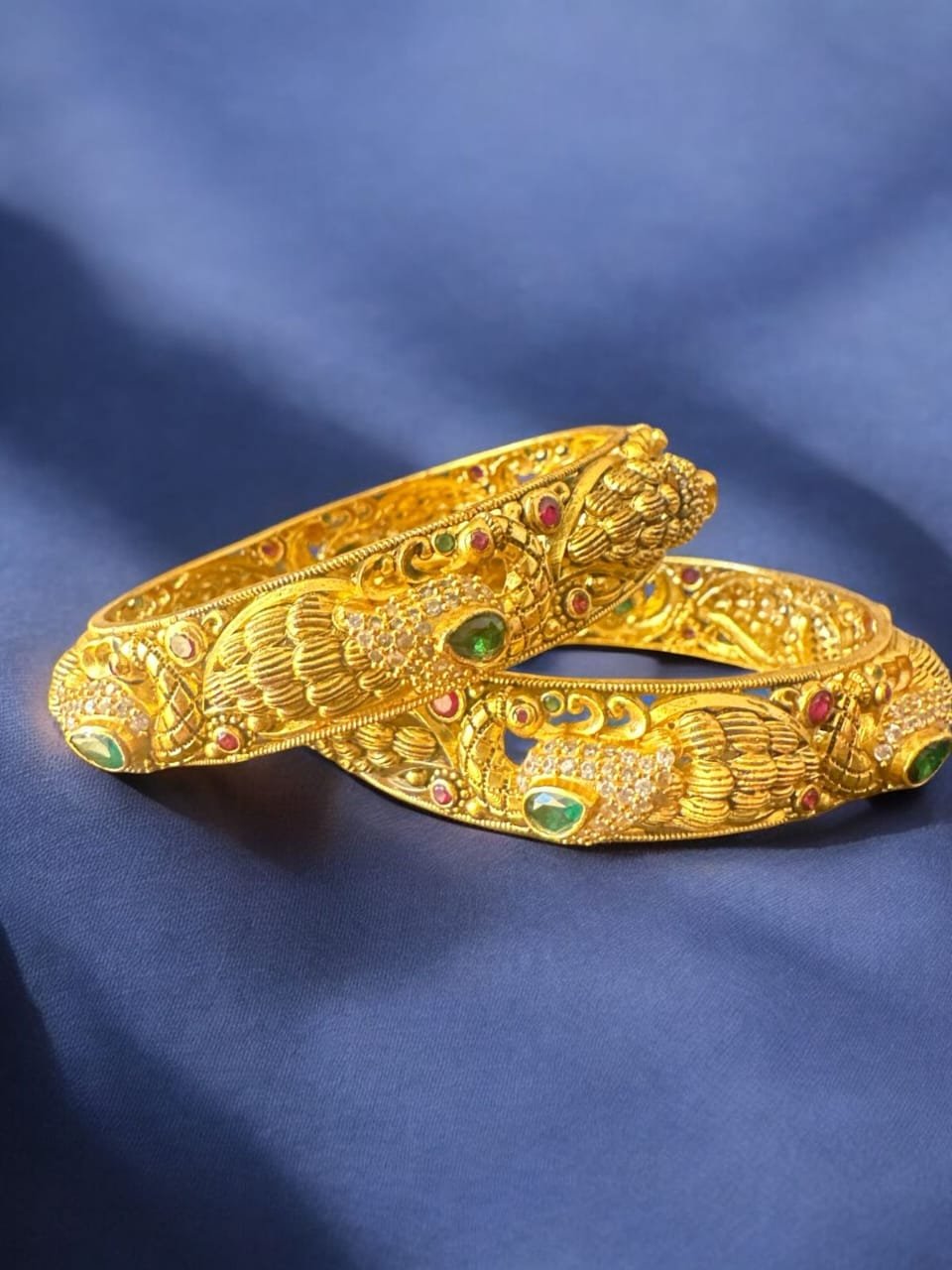 Peacock design and green and red stones with gold polish