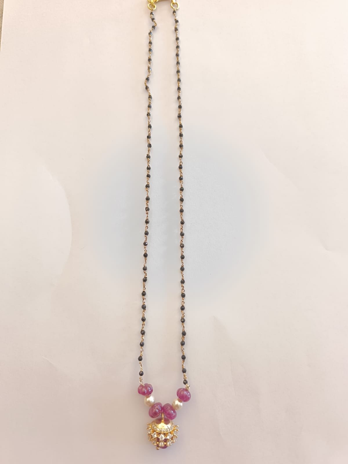 Red colour pumpkin beads and cz stones pendent with black beads chain with gold polish