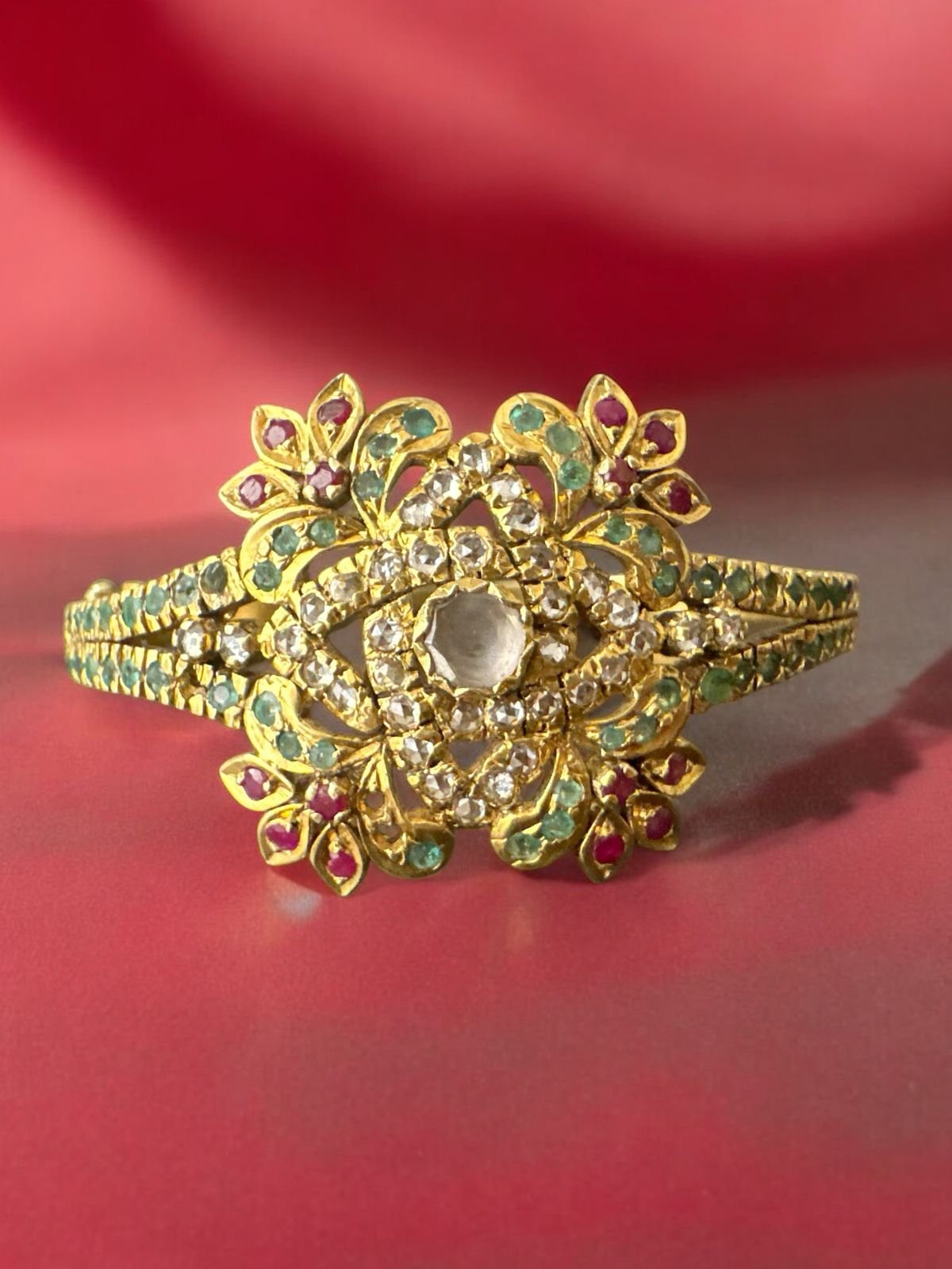 Single bangle with gold polish green and red stones white stones cz stones