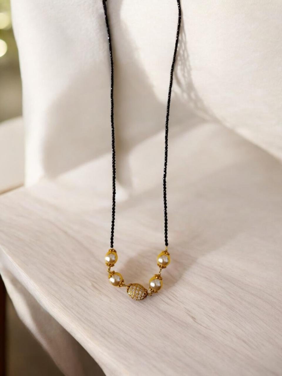 Swarovski  pearls   and gold ball  pendent with single line black beads chain